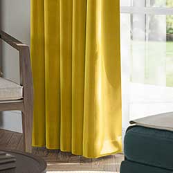 A beautiful set of white taped wooden blinds in a very bright room